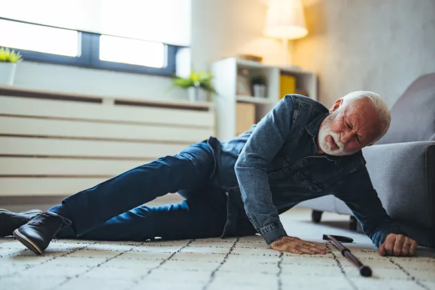 Äldre man ligger på golvet efter ett fall, fotografi. Foto: iStock/dragana991